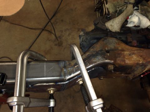 1993 Ford Bronco - Close-up view of vehicle frame modification with clamps and engine components.