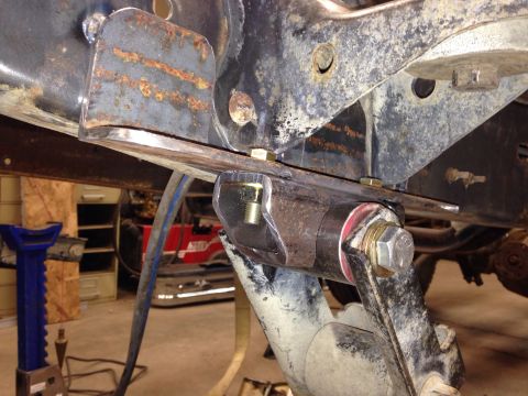 1993 Ford Bronco - A close-up view of vehicle suspension components and frame, showing signs of rust and modification.