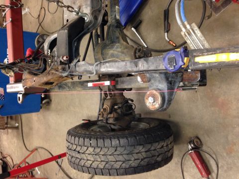 1993 Ford Bronco - Close-up view of a vehicle's suspension and tire assembly, likely undergoing maintenance or repair.