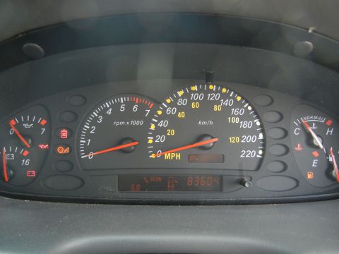 1999 Ford Fairlane - Dashboard gauges including speedometer, tachometer, fuel, and temperature. Odometer reads 83604.