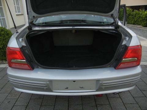 1999 Ford Fairlane - The rear of a silver sedan with its trunk open, showing the cargo area and bumper.