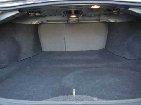 1999 Ford Fairlane - The interior of a car trunk is shown, speakers and carpeted surfaces.