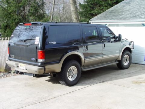 2003 Ford Excursion - This Ford Excursion is parked in front of a garage.
