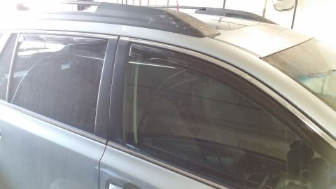 2014 Subaru Outback - Dark window visors are installed on the side of a silver SUV.