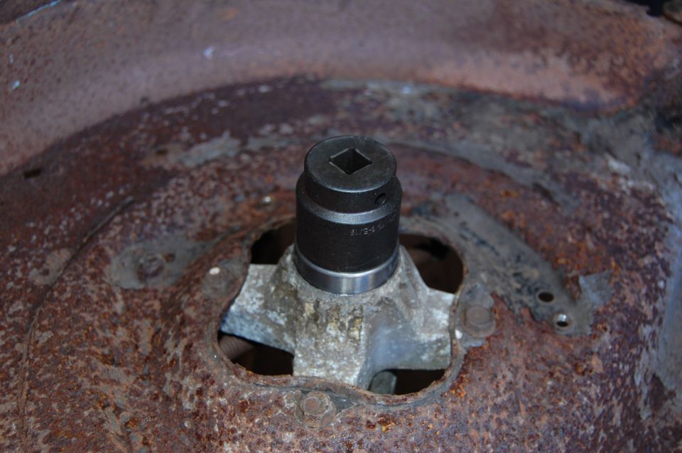 Socket on a rusty metal part with visible text '1.24.1'
