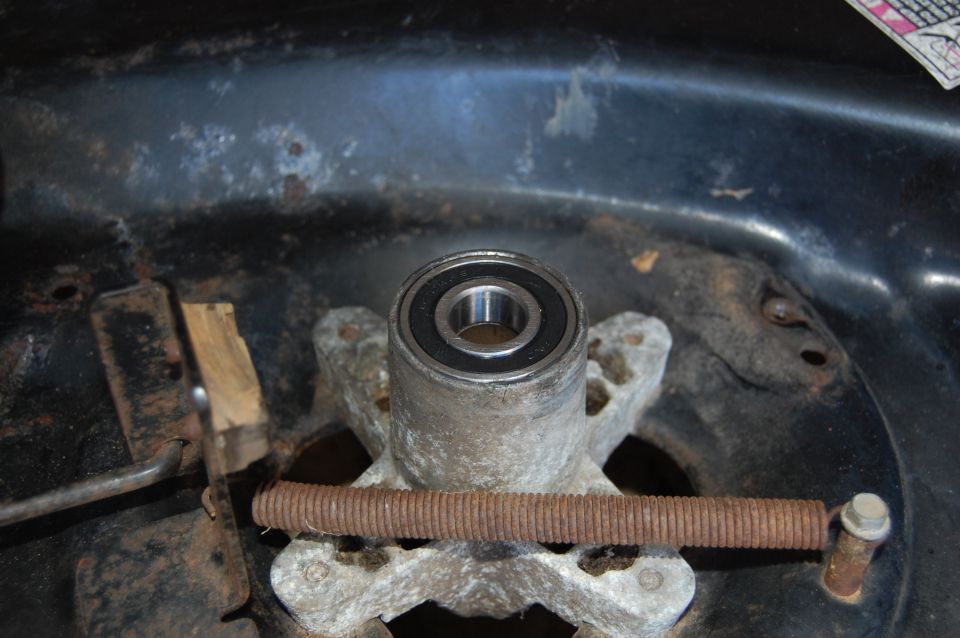 Lawn mower deck spindle bearing with rusty spring