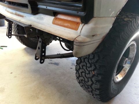 1982 Jeep Wagoneer - Front view of a white Jeep Wagoneer, highlighting its bumper, turn signal, and off-road tire.