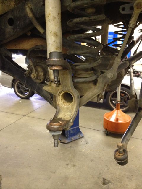 2005 Jeep Wrangler - Front suspension part of a Jeep, possibly undergoing maintenance or repair.