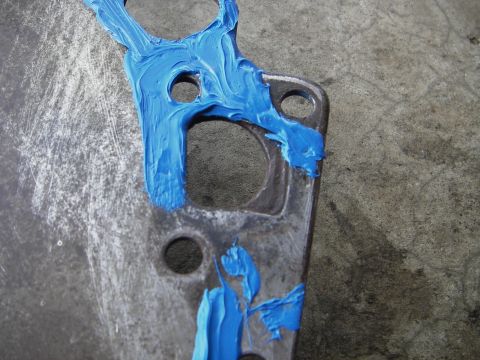 1972 Ford Ranchero - A close-up view of an automotive gasket with blue sealant applied to its surface.