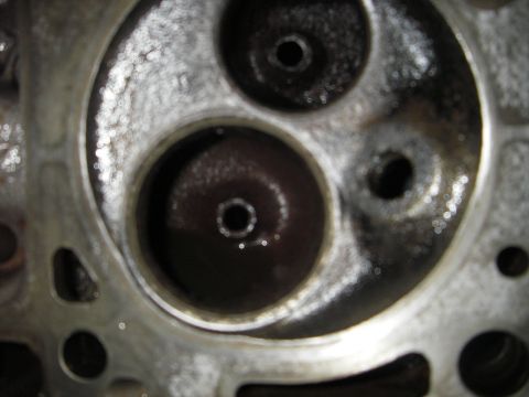 1972 Ford Ranchero - This image shows the combustion chambers of an engine cylinder head, with visible carbon deposits.