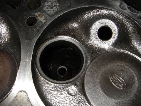 1972 Ford Ranchero - Close-up of an engine cylinder head, showing a Ford logo stamped on one of the valves.