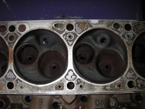 1972 Ford Ranchero - Close-up of an engine cylinder head, showing combustion chambers and bolt holes. Text from website visible.