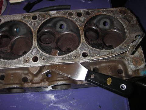 1972 Ford Ranchero - Scraping gasket material off an engine block and cylinder head assembly.