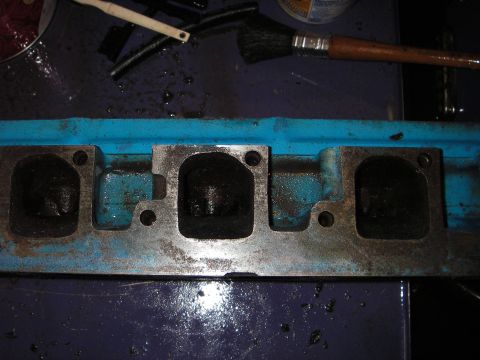 1972 Ford Ranchero - A close-up view of a dirty engine part, possibly a cylinder head or exhaust manifold.