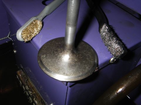 1972 Ford Ranchero - Cleaning tools are positioned around an engine valve, suggesting maintenance or repair work.