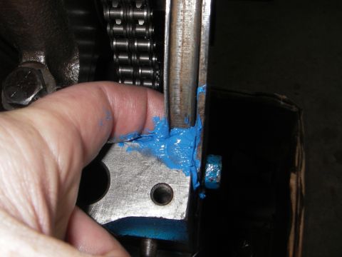 1972 Ford Ranchero - Applying grease to engine part near timing chain.