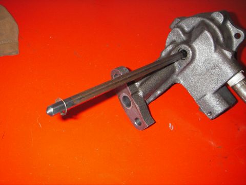 1972 Ford Ranchero - A steering gear assembly is shown with a metal rod extending from it, resting on an orange surface.