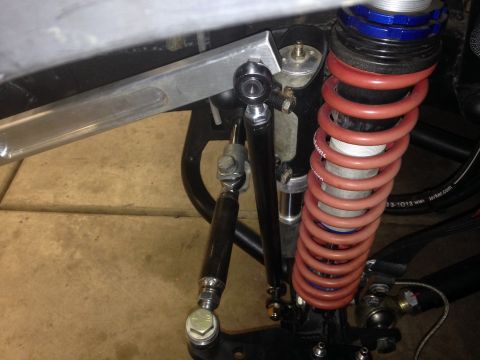 1987 Suzuki Samurai - Custom suspension component, possibly for an off-road vehicle, a red coilover shock and adjustable linkages.