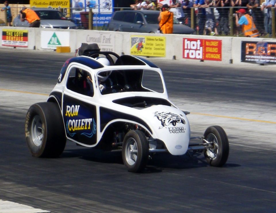 Drag racing car with 'RON COLLETT' and 'BRUTE POWER' text on the side, on a track