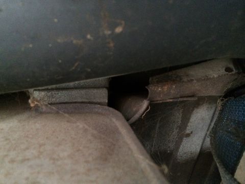 1964 Ford Ranchero - Rusted metal bracket and fuel tank strap detail, likely from a vehicle's undercarriage.