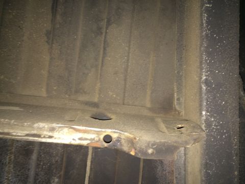 1964 Ford Ranchero - The underside of a vehicle bed shows signs of wear and tear, with visible rust and holes.
