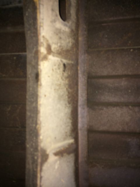 1964 Ford Ranchero - The underside of a vehicle's frame and bed show signs of wear and tear.