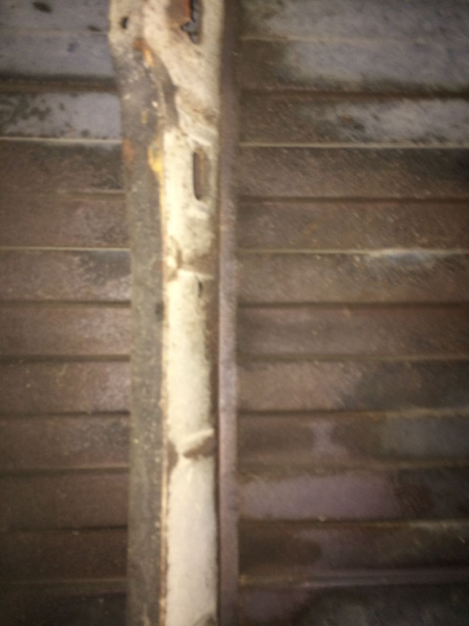 Rusted metal frame and ribbed surface