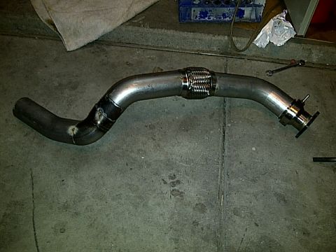 1995 Ford Probe - Custom exhaust pipe with a flex joint and a flange is shown on a concrete surface.