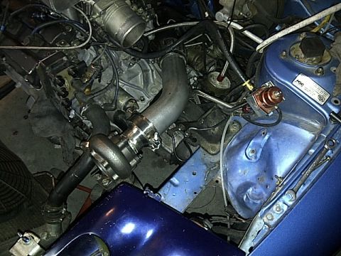 1995 Ford Probe - Close-up view of a modified engine bay a turbocharger and vibrant blue painted components.