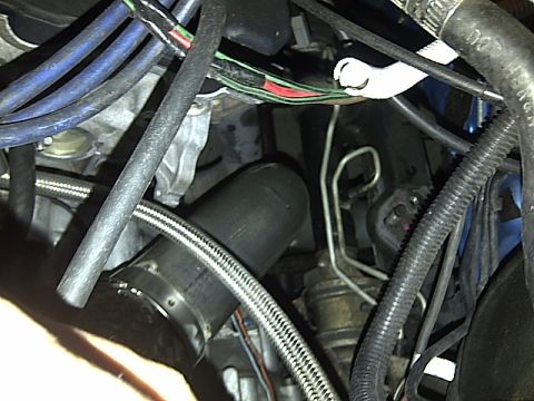 1995 Ford Probe - Close-up view of an engine bay, showing complex wiring and plumbing.