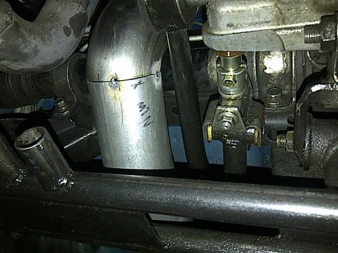 1995 Ford Probe - Close-up of a modified exhaust pipe with visible welding and markings.