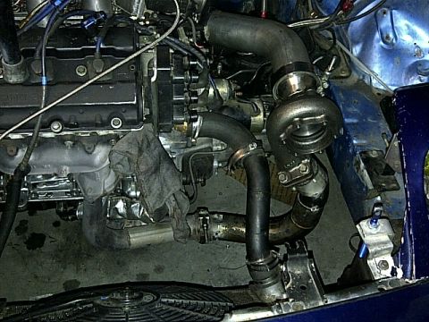 1995 Ford Probe - This photo shows a custom turbocharged engine setup with various pipes and components visible.