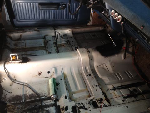 1972 Ford Ranchero - The interior of a 1972 Ford Ranchero is shown stripped down for restoration, revealing the floor pan and dashboard.
