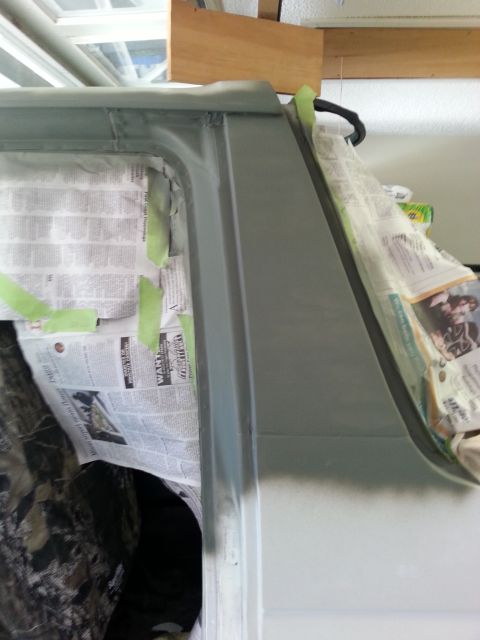 1992 Ford Bronco - Vehicle body panel prep work, showing newspaper and tape protecting interior during body repair.