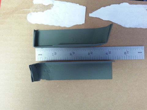 1992 Ford Bronco - Two automotive trim pieces are shown with a ruler, suggesting they are parts for repair or replacement.