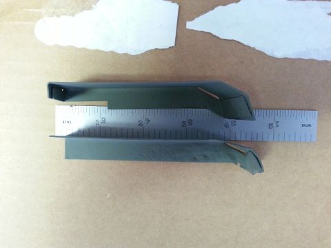 1992 Ford Bronco - Metal trim pieces measured with a ruler. No vehicle is visible in the photo.