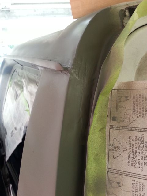 1992 Ford Bronco - Bodywork is underway on a vehicle, with primer and masking tape visible.