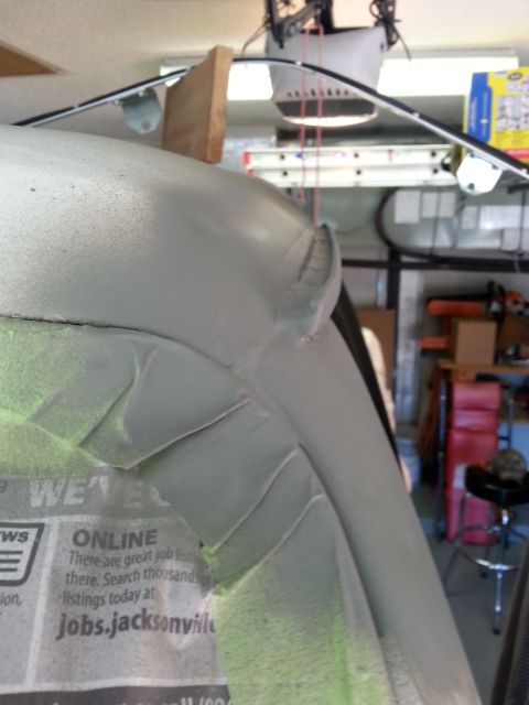 1992 Ford Bronco - A close-up of a vehicle's body panel shows taped newspaper and a seam, suggesting repair work.