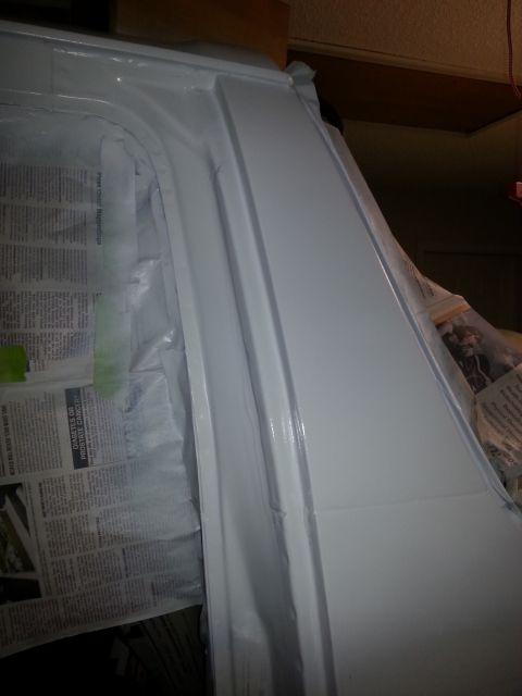 1992 Ford Bronco - Close-up of a vehicle body panel undergoing repair and painting.