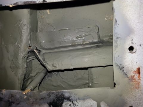 1992 Ford Bronco - Close-up view of the vehicle's undercarriage, showing repair work and undercoating.
