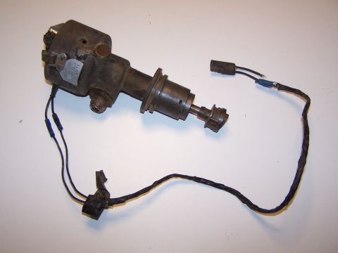 1965 Ford 427 - A vintage automotive distributor with attached wiring sits on a plain background.