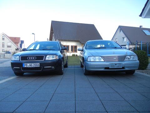 1999 Ford Fairlane - Two sedans, an Audi and a silver sedan, are parked side-by-side in a driveway.