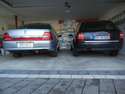 1999 Ford Fairlane - Two sedans, a silver one and a black Audi wagon, are parked side-by-side in a garage.