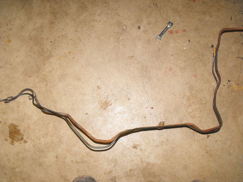 The first 51" replacement line bent to mimic the original line. No tools required as 3/16 inch high copper content polymer coated lines are easy on the fingers. This takes you from the proportioning valve, with the new fitting on the line, to the female union block just under the driver's feet.