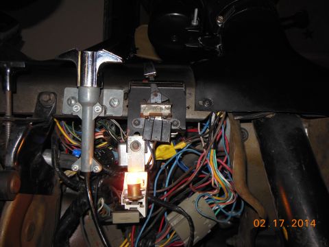 1979 Ford F-150 - A complex dashboard wiring harness with many colorful wires and a single illuminated bulb.