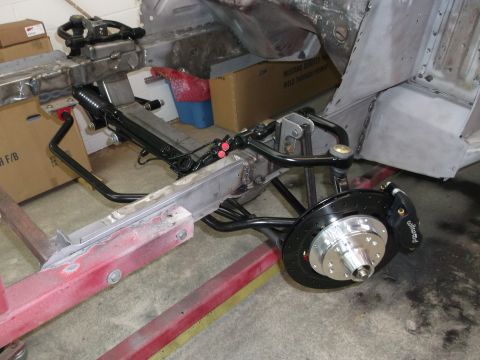 1967 Ford Mustang - Front suspension and brake assembly of a car chassis undergoing restoration or modification.