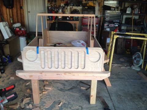 2005 Jeep Wrangler - A wooden replica of a Jeep's front end is under construction in a garage.