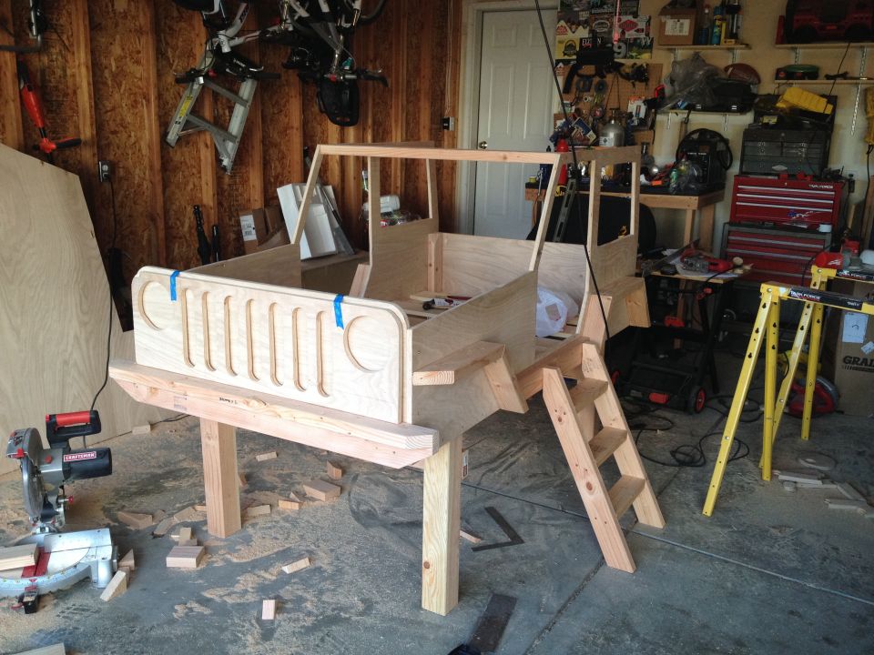 Wooden Jeep bed frame under construction with grille detail