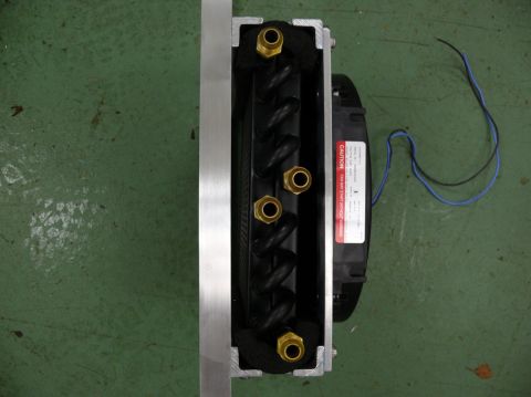 1976 Chevrolet Corvette - An oil cooler assembly with a fan and visible brass fittings is shown from a top-down perspective.