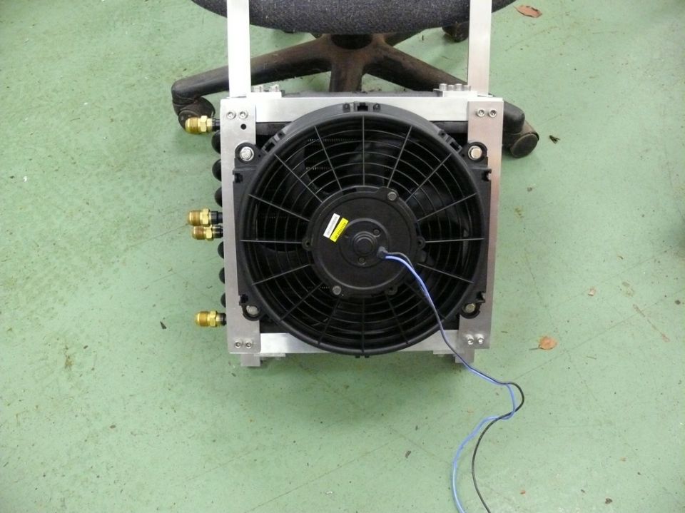 Radiator fan assembly with aluminum frame and brass fittings, mounted on a chair base